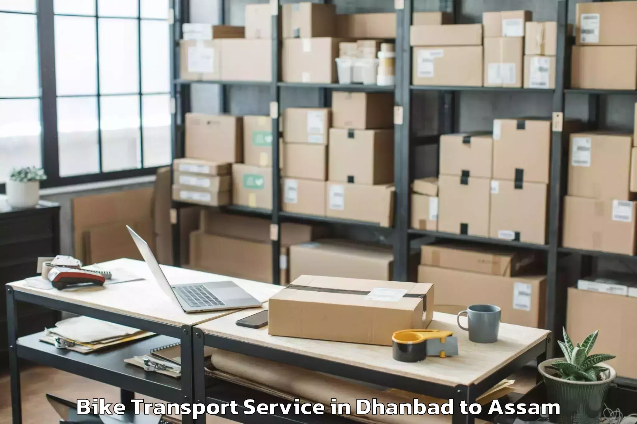 Book Dhanbad to Dhakuakhana Pt Bike Transport Online